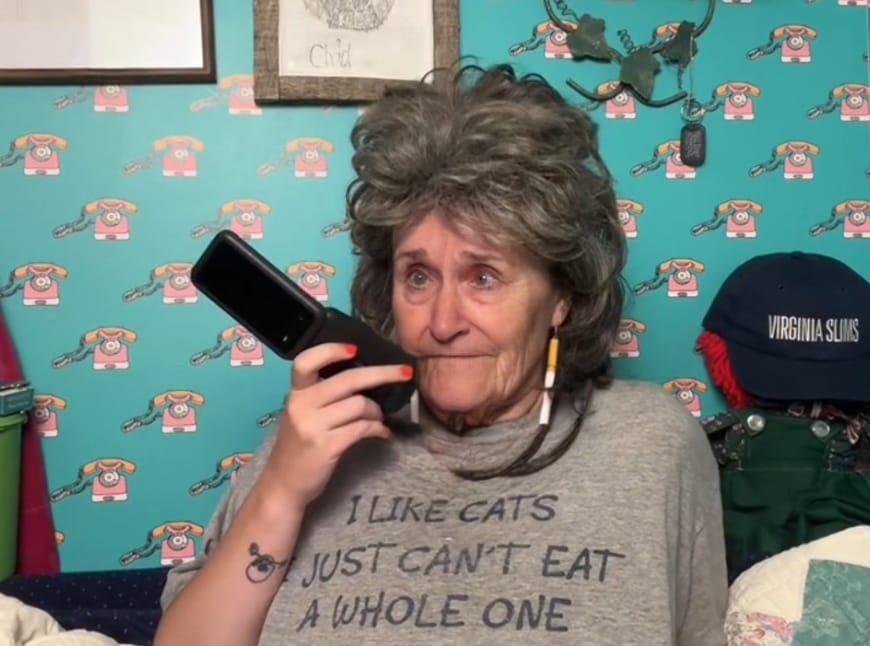Sarah Soda in character as Sue Dillon, holding a phone during a live TikTok prank call